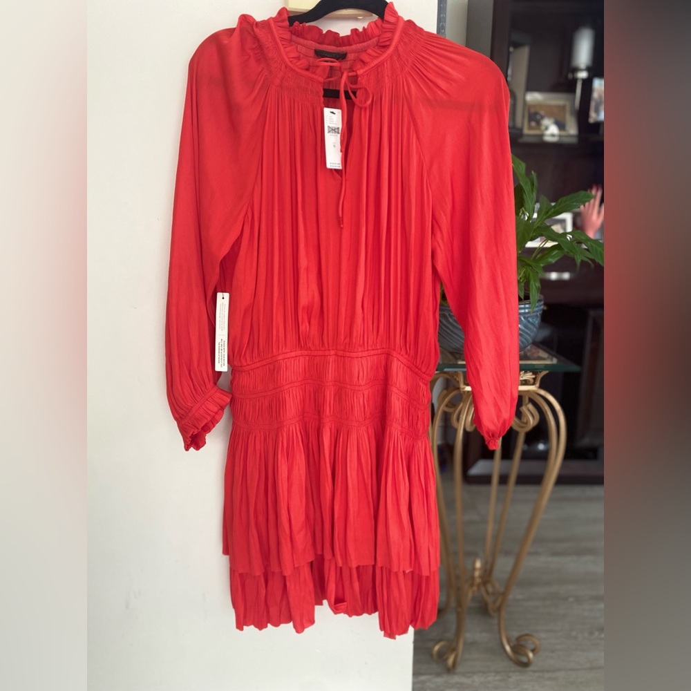 This mini dress is so lovely with its notched ruffle collar, tied